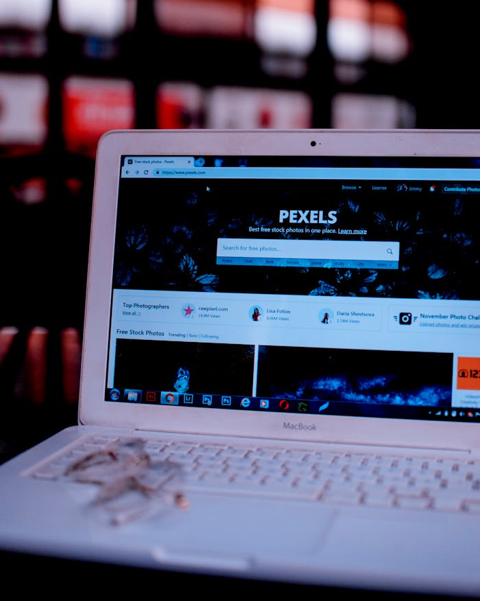 Laptop on a desk showing the Pexels homepage, highlighting its web interface.